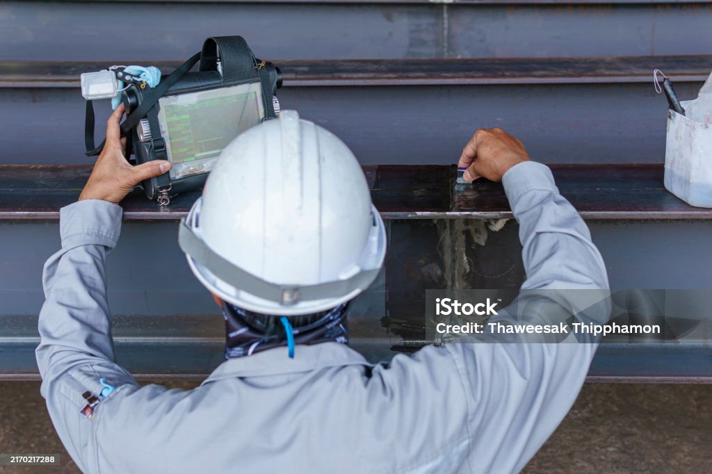 Inspectors are Inspection defects in Welded Steel H-beam add joints with Process Ultrasonic Testing (UT) of Non-Destructive Testing (NDT)
